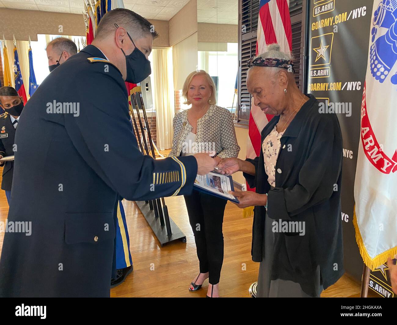 Col. Craig Martin, Fort Hamilton Garrison Commander, presents guest speaker Lorraine West with a token of appreciation at the Women’s Equality Day Observance held at the Community Club on Fort Hamilton, N.Y., Aug. 31, 2021. Stock Photo