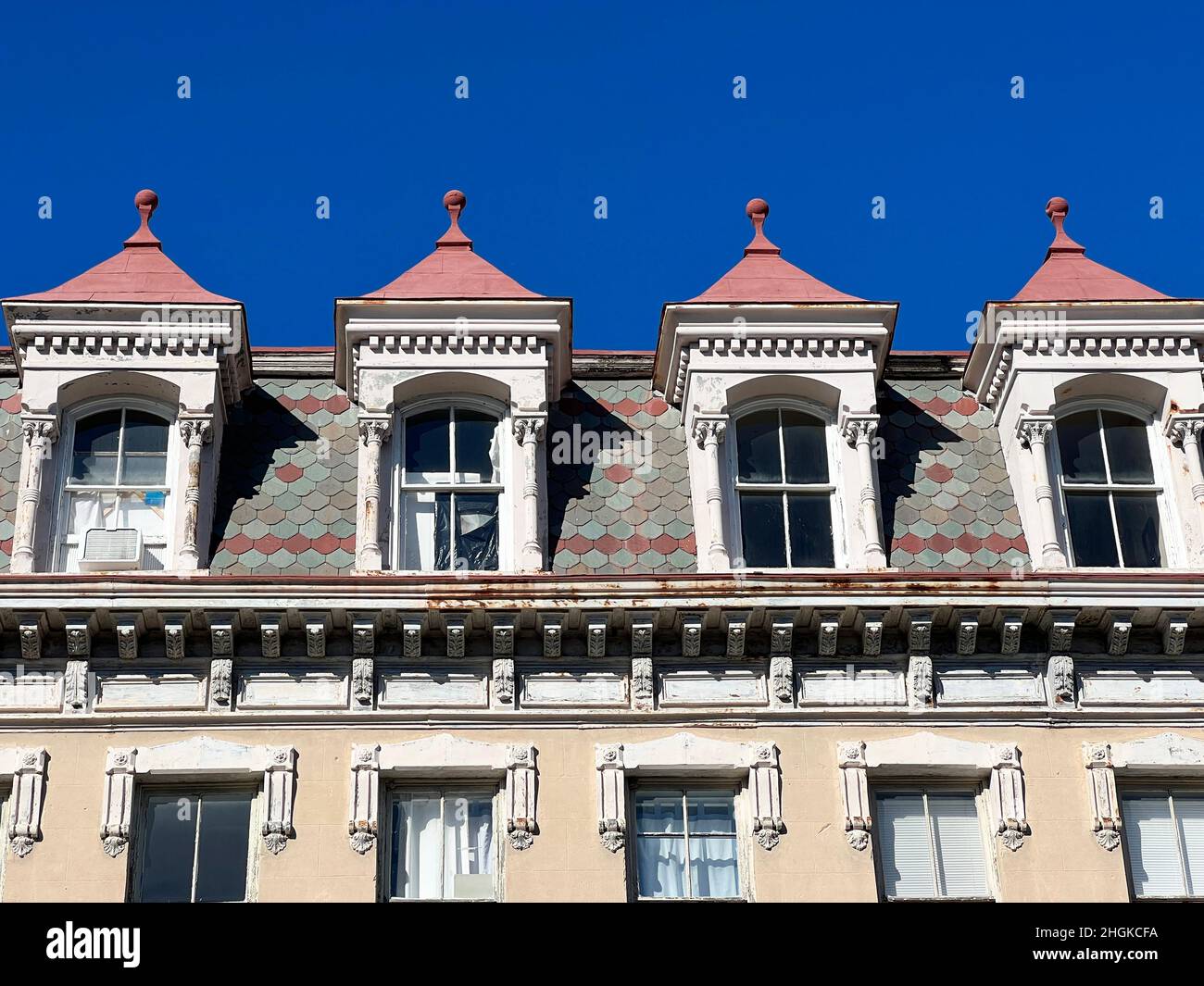 Closeup of slate shingles, detailed gables on a mansard roof and dentil molding in historic Charleston, South Carolina. Stock Photo