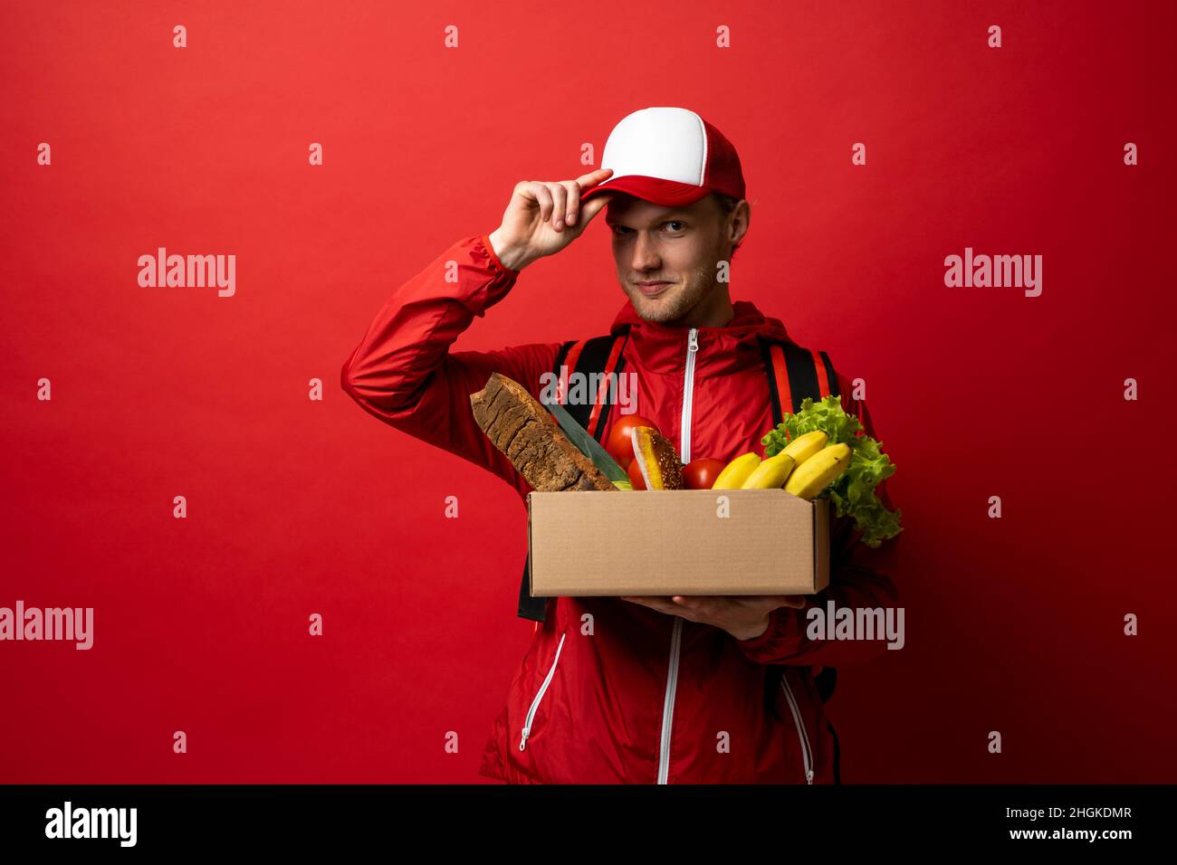 Food delivery service. Male courier holding grocery bag. Express food ...