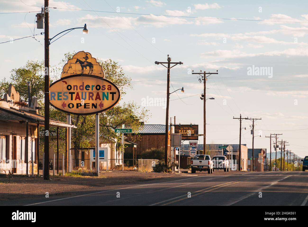 The main highway passing through the village of Magdalena, New Mexico, featuring an old sign for