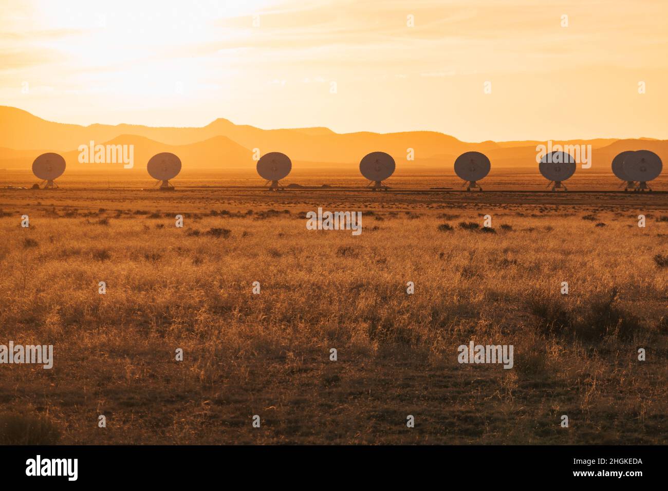Silhouettes of radio telescope dishes bunched together at the Karl G. Jansky Very Large Array on the Plains of San Agustin, New Mexico Stock Photo