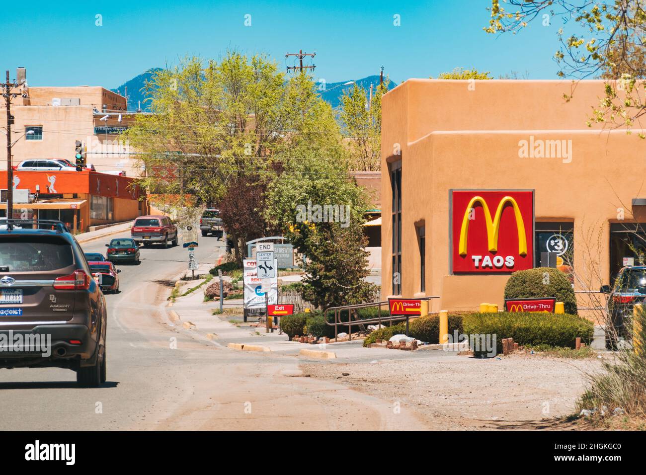 a McDonald's restaurant sign in Taos, this fast food chain location is housed in a traditional adobe styled building Stock Photo