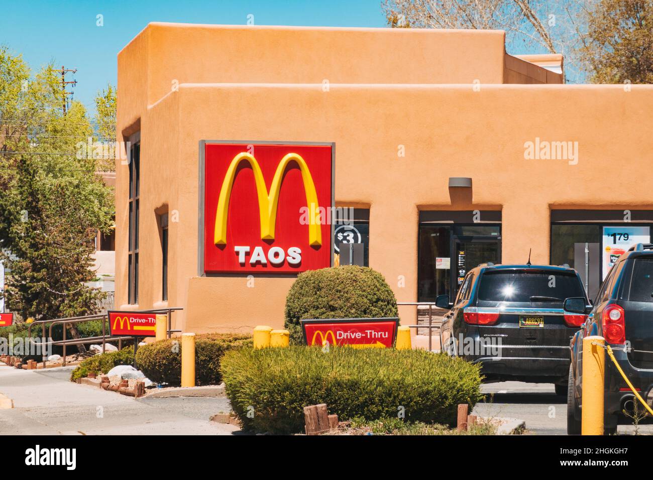 a McDonald's restaurant sign in Taos, this fast food chain location is housed in a traditional adobe styled building Stock Photo