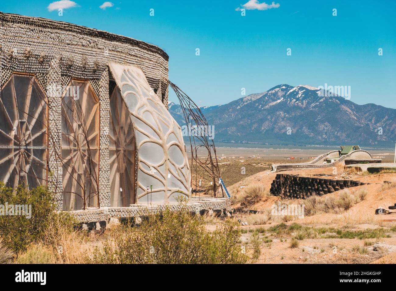 Earthship Biotecture near Taos, New Mexico, with self-sustaining homes made from natural and upcycled materials such as tires and glass bottles Stock Photo
