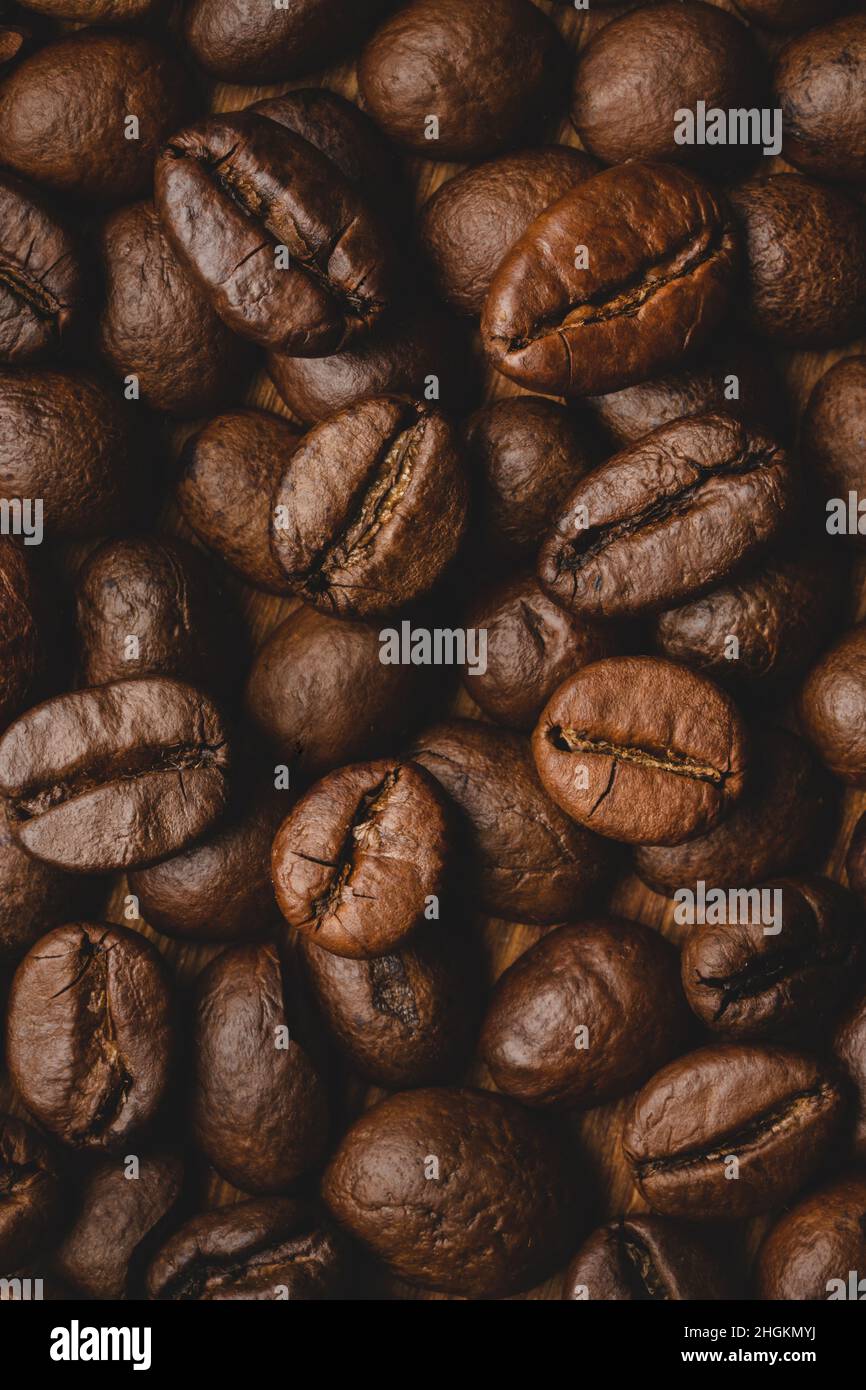 Coffee beans roasted full frame background Close up macro dark brown ...