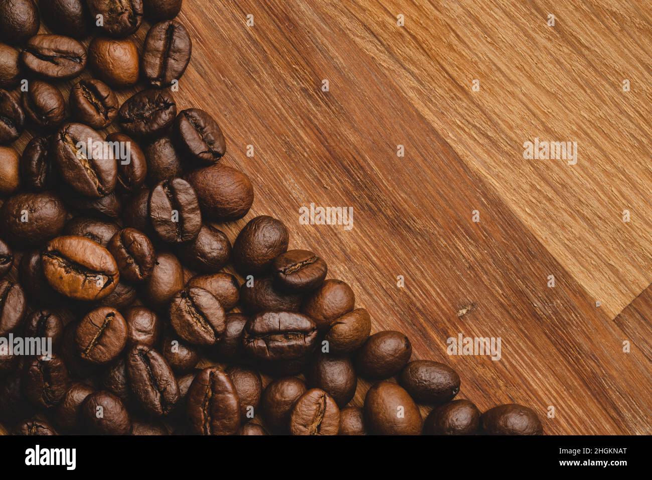 Coffee beans roasted on wooden background Close up macro copy space Stock Photo