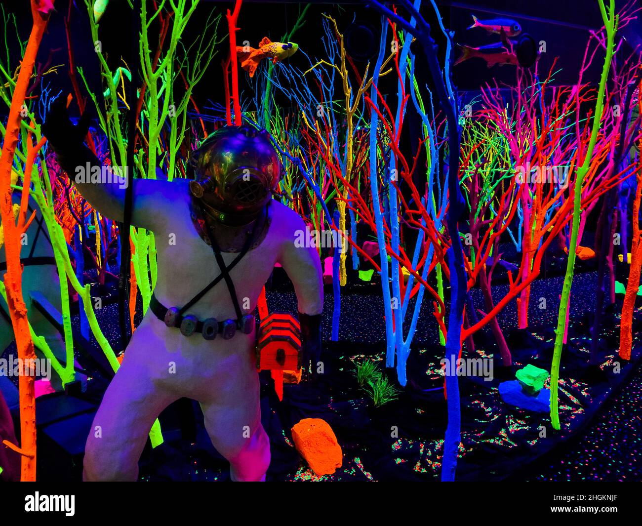 a diver surrounded by fluorescent sea kelp inside Meow Wolf, an immersive art experience in Santa Fe, New Mexico, USA Stock Photo