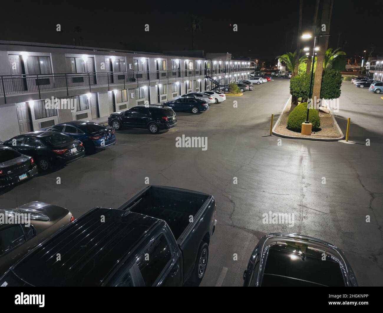 a busy two-story budget motel parking lot in Phoenix, Arizona Stock Photo