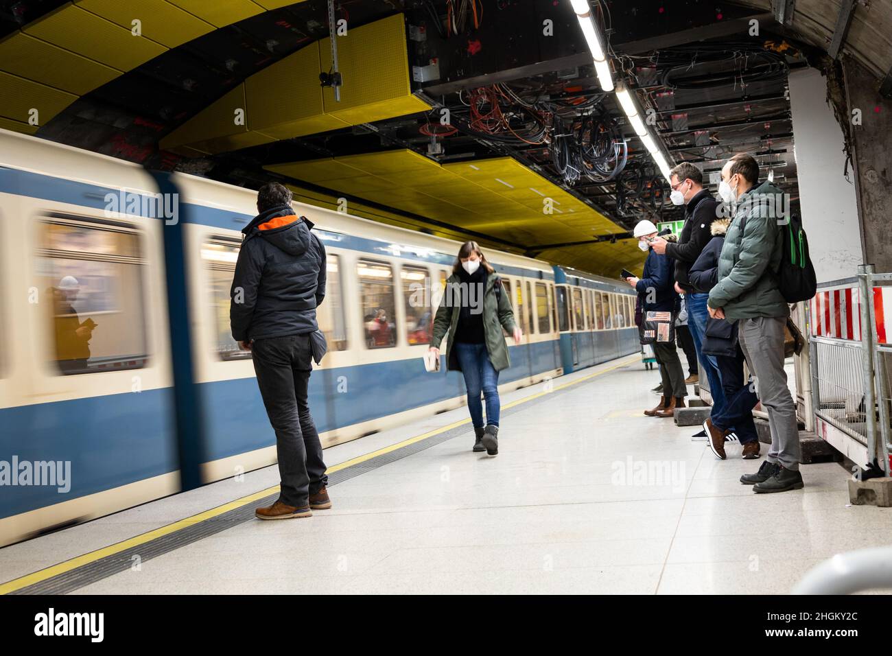 Munich, Germany. 21st Jan, 2022. U-Bahn riders wait on the platform at Sendlinger Tor. While cases of Covid-19 continue to surge, there is resistance from both politicians and the public to put further restrictions in place. The seven-day incidence in the city of Munich has reached 1,122. Yet, many people could be seen shopping on the afternoon of January 21, 2022. (Photo by Alexander Pohl/Sipa USA) Credit: Sipa USA/Alamy Live News Stock Photo