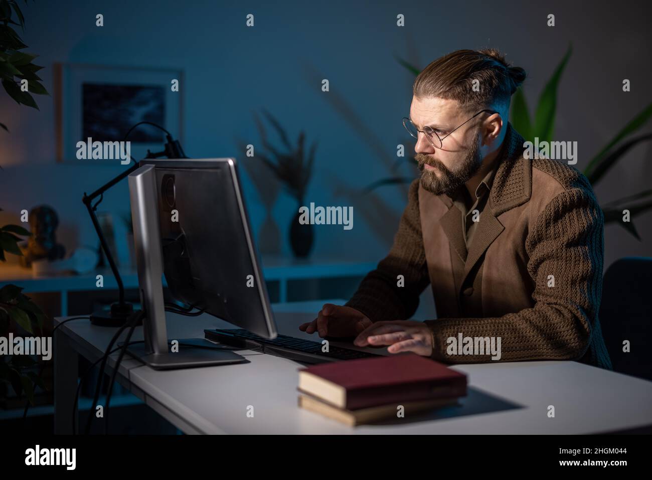 Man working late on pc Stock Photo