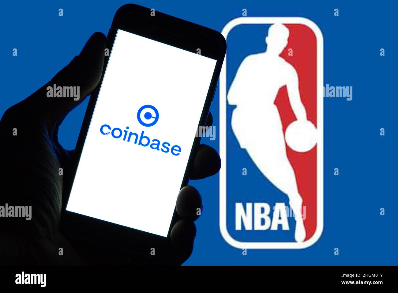 Spain. 12th Jan, 2022. In this photo illustration a Coinbase logo seen displayed on a smartphone with a NBA logo in the background. (Photo by Thiago Prudencio/SOPA Images/Sipa USA) Credit: Sipa USA/Alamy Live News Stock Photo