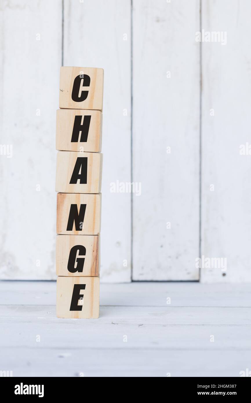 wooden cube, with the word change, with white wooden background Stock Photo