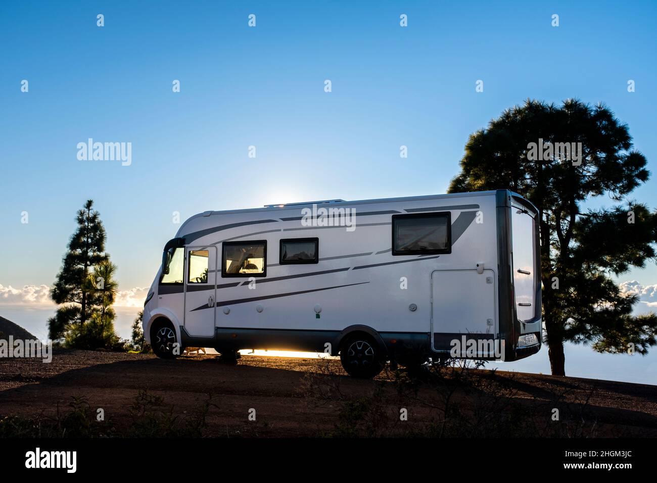 Big camper motorhome parked in off road nature space to enjoy total freedom. Off grid lifestyle vanlife. Travel with camping car and discover the beau Stock Photo