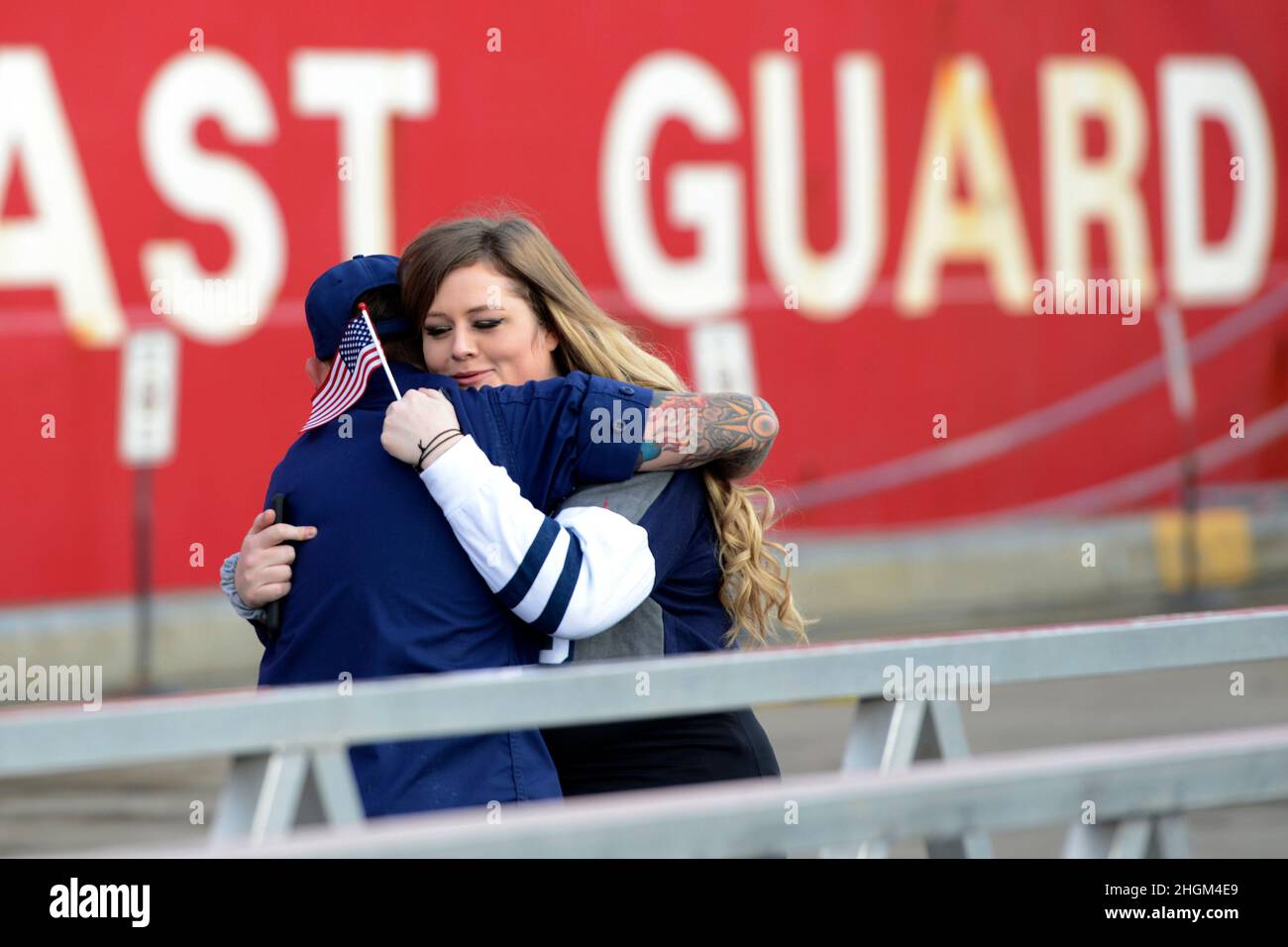 Seattle, United States. 20 November, 2021. A family member embraces a member of the crews aboard the U.S. Coast Guard Cutter Healy after it arrived at homeport following four and a half month deployment in the Arctic, November 20, 2021 in Seattle, Washington. Credit: PO3 Michael Clark/US Coast Guard Photo/Alamy Live News Stock Photo