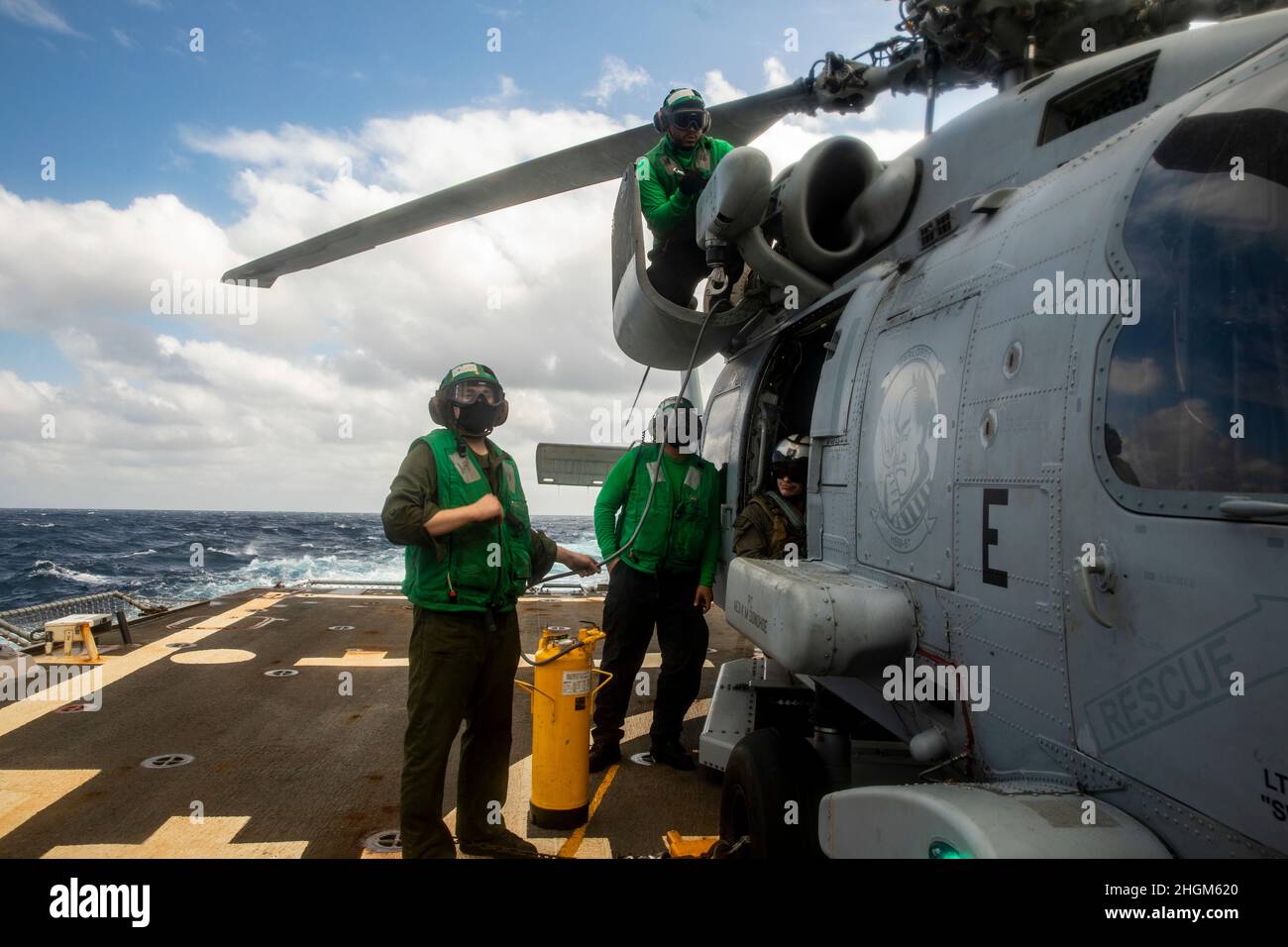 SOUTH CHINA SEA (Jan. 18, 2022) Sailors conduct maintenance on an MH-60R helicopter aboard Arleigh Burke-class guided-missile destroyer USS Ralph Johnson (DDG 114). Ralph Johnson is assigned to Task Force 71/Destroyer Squadron (DESRON) 15, the Navy’s largest forward-deployed DESRON and the U.S. 7th fleet’s principal surface force. (U.S. Navy photo by Mass Communication Specialist 2nd Class Samantha Oblander) Stock Photo