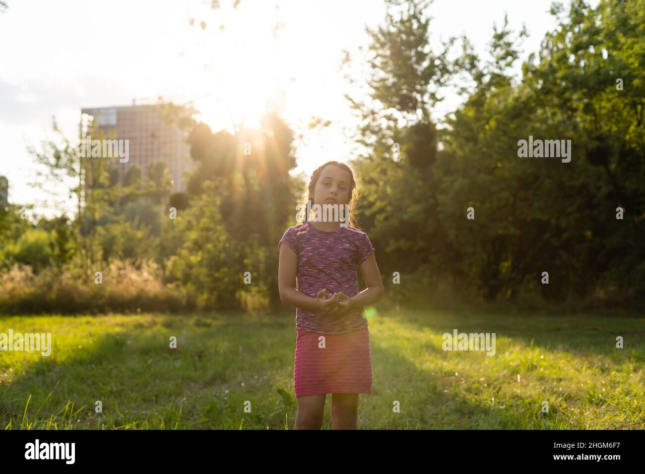 Cute little girl on the meadow in spring day Stock Photo - Alamy