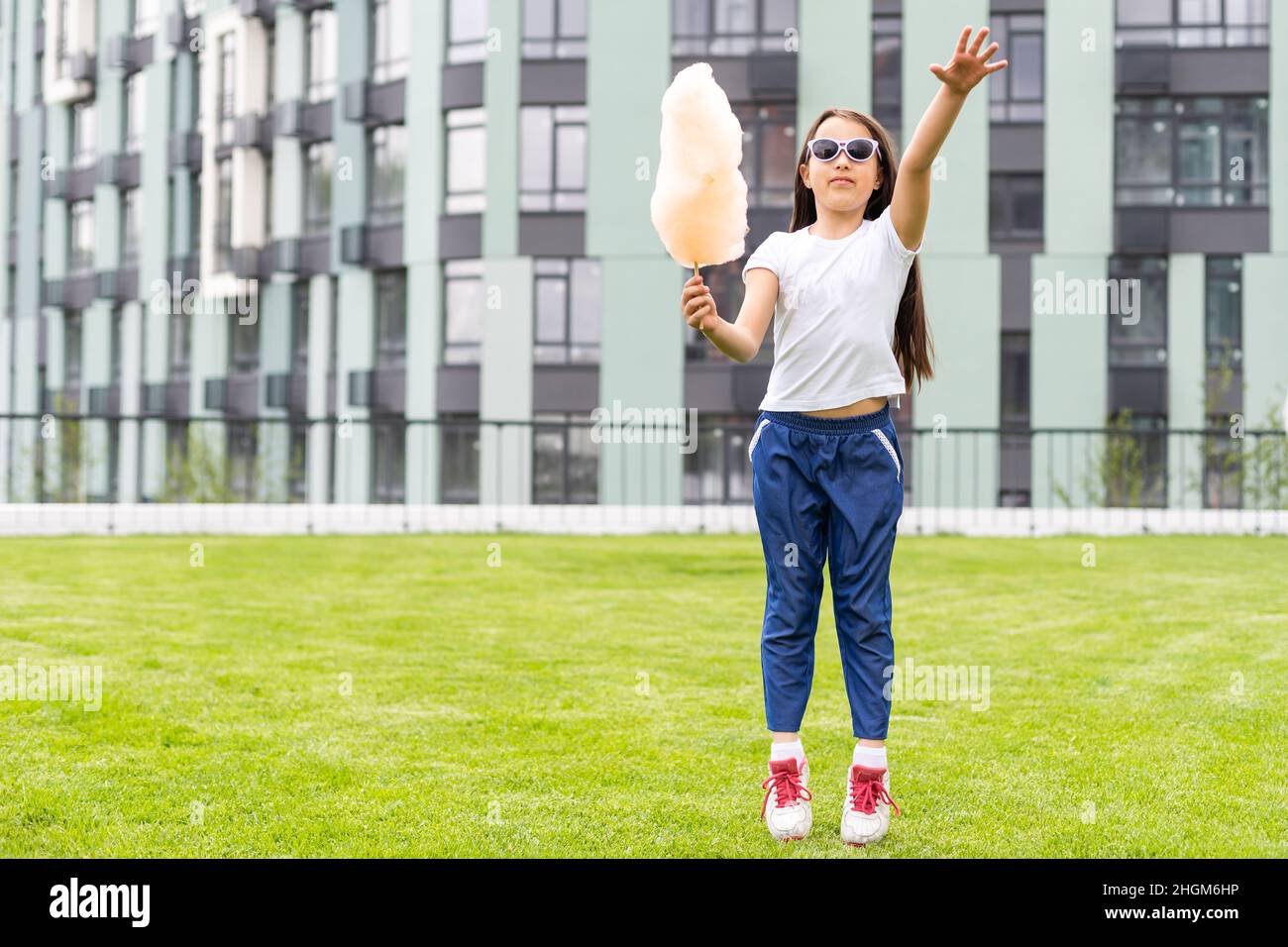 Little girl walking on the green lawn in the park Stock Photo - Alamy