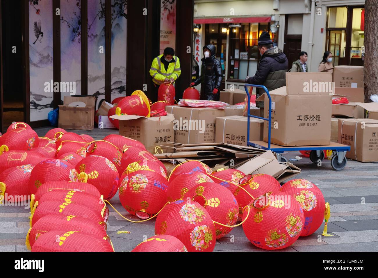London, UK, 21st Jan, 2022. Workers in London's Chinatown take down the area's iconic red lanterns and replace with this year's versions bearing current sponsors' names, ahead of Chinese New Year on February 1st, that will see the Chinese community welcoming in the Year of the Tiger. Credit: Eleventh Hour Photography/Alamy Live News Stock Photo