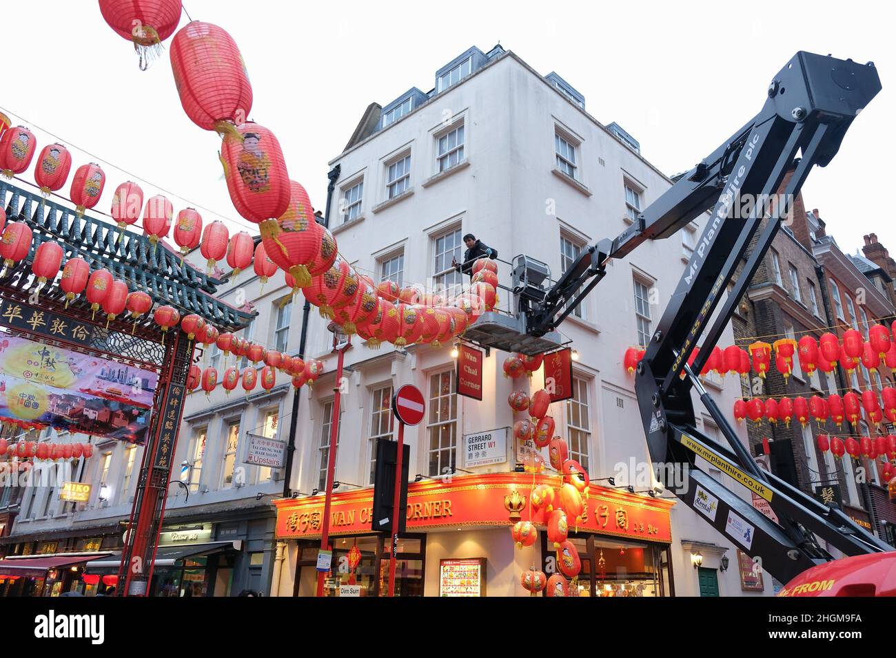 London, UK, 21st Jan, 2022. Workers in London's Chinatown take down the area's iconic red lanterns and replace with this year's versions bearing current sponsors' names, ahead of Chinese New Year on February 1st, that will see the Chinese community welcoming in the Year of the Tiger. Credit: Eleventh Hour Photography/Alamy Live News Stock Photo
