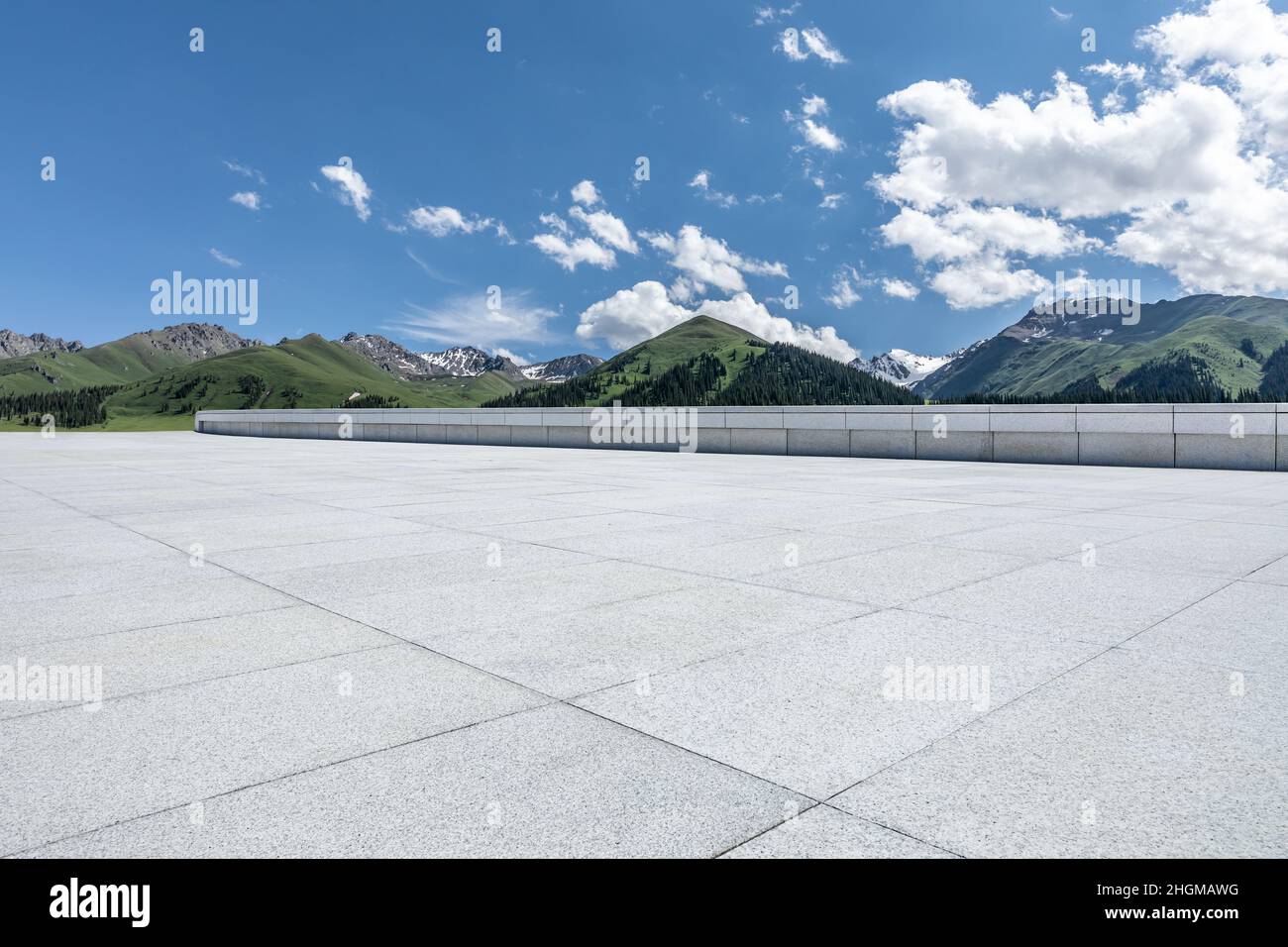 Empty square floor and mountains under blue sky Stock Photo