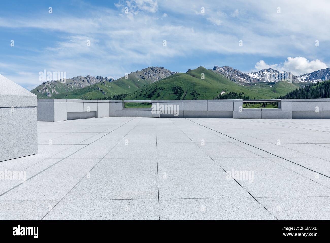 Empty square floor and mountains under blue sky Stock Photo