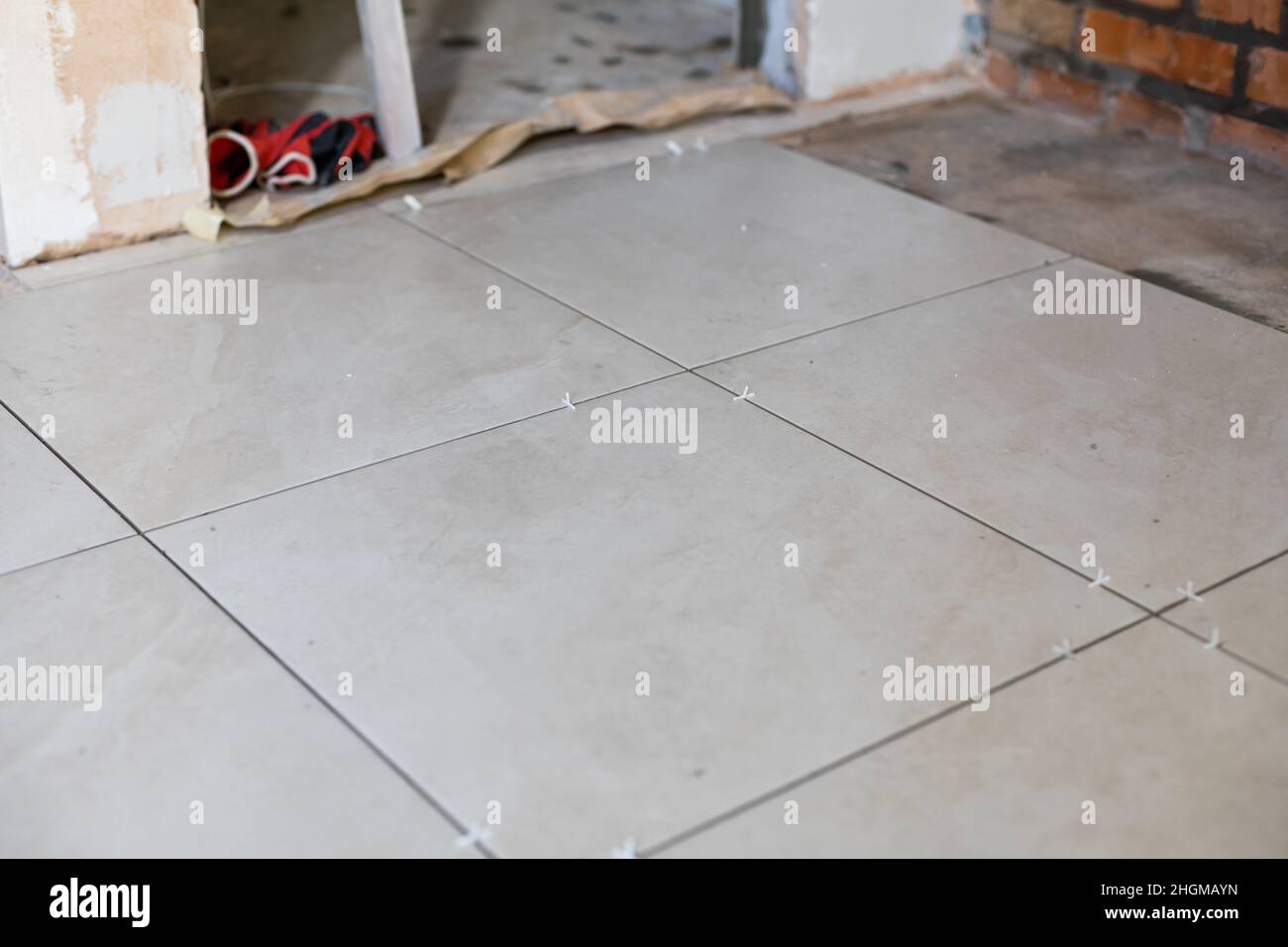 Tiles In Construction Close-up Installing tiles floor in construction work Stock Photo - Alamy