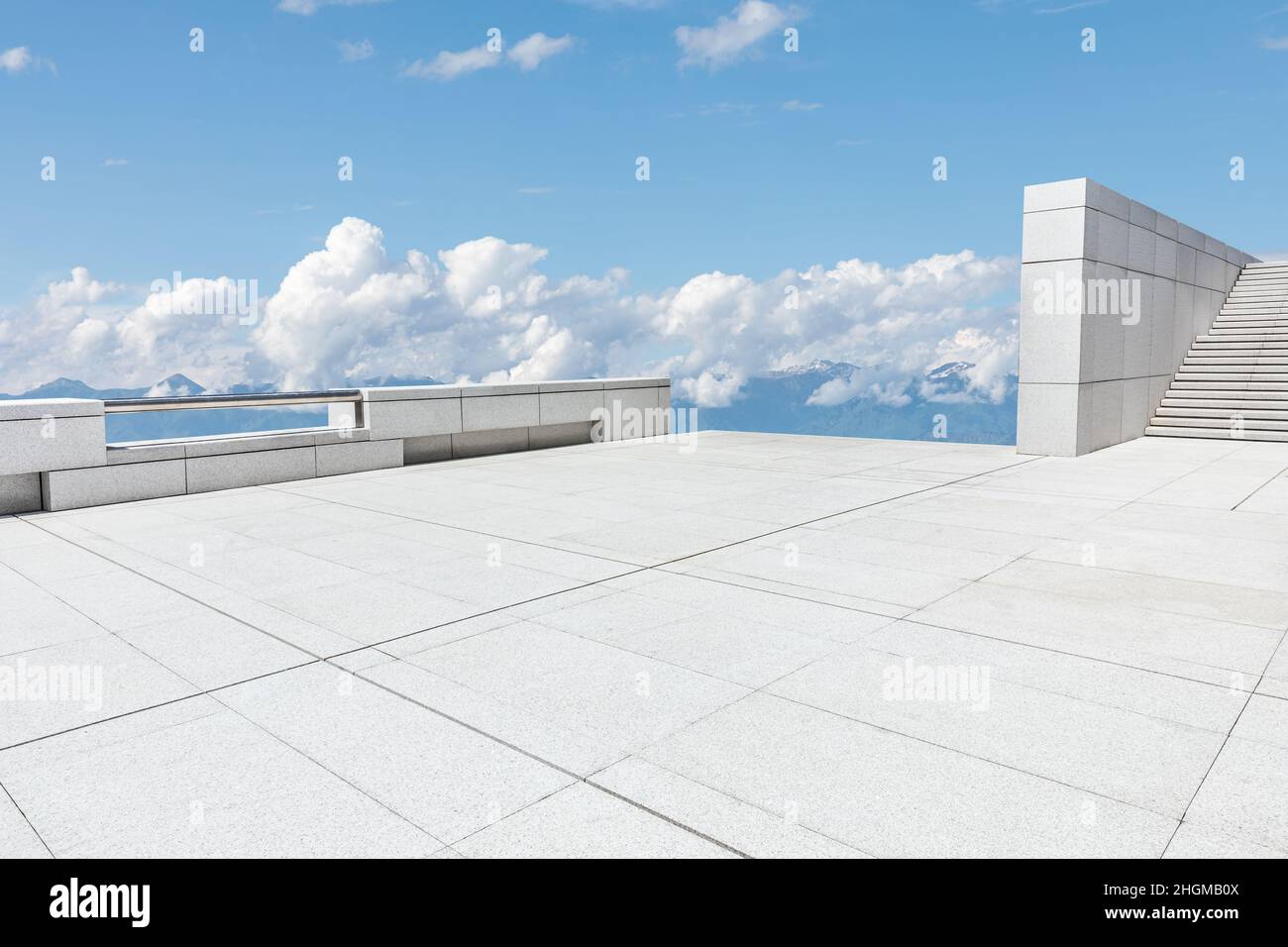 Empty square floor and mountains under blue sky Stock Photo