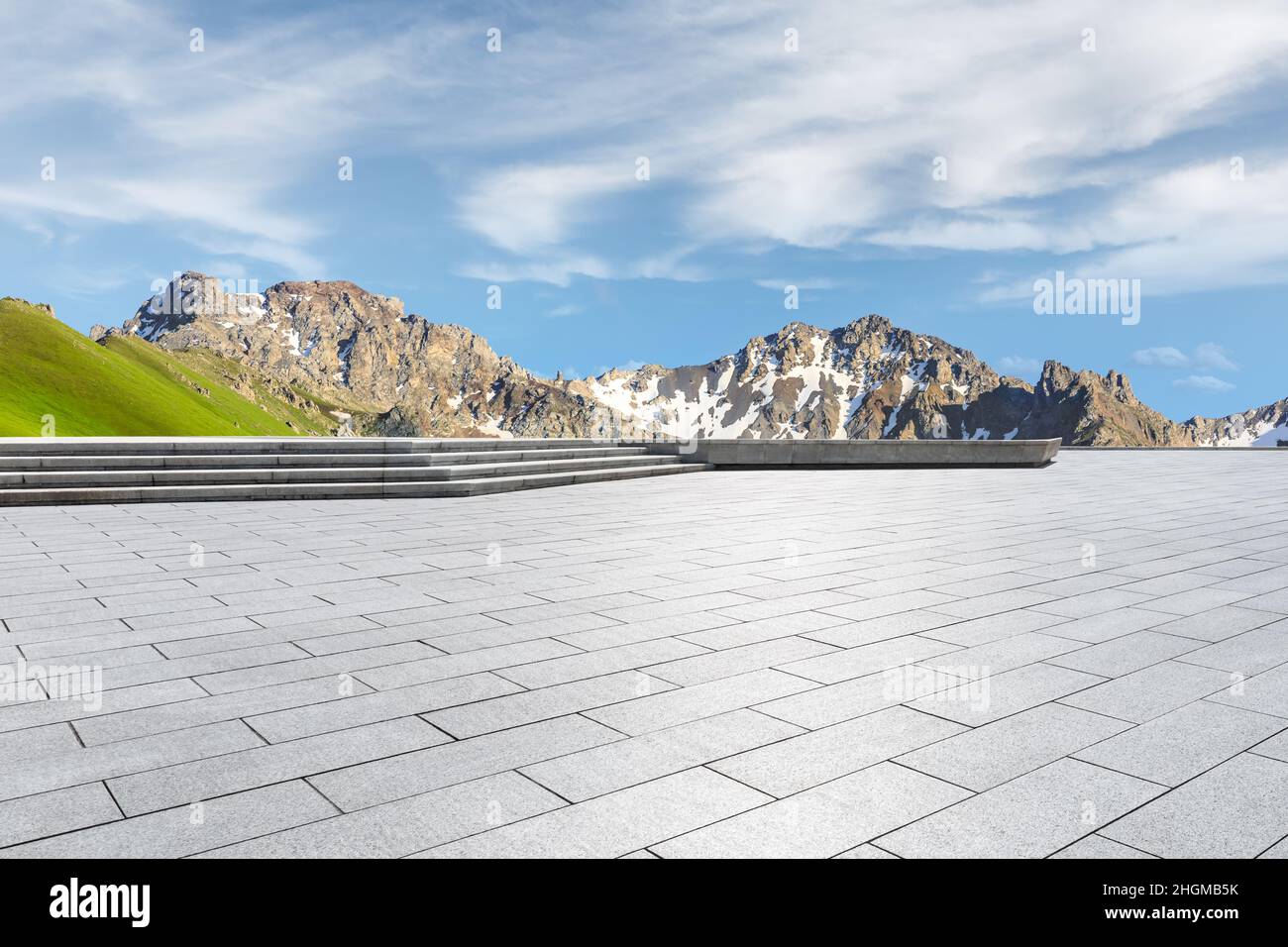 Empty square floor and mountains under blue sky Stock Photo