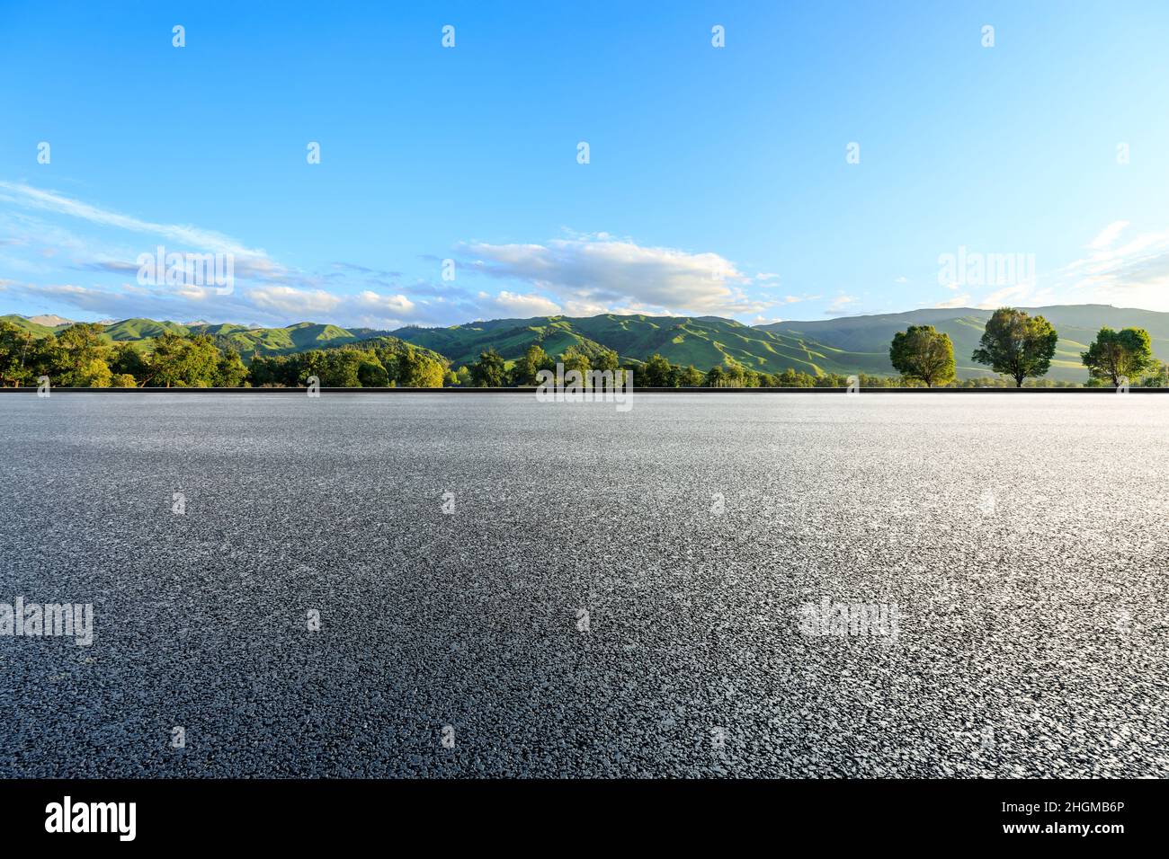 Asphalt road and mountain under blue sky Stock Photo - Alamy