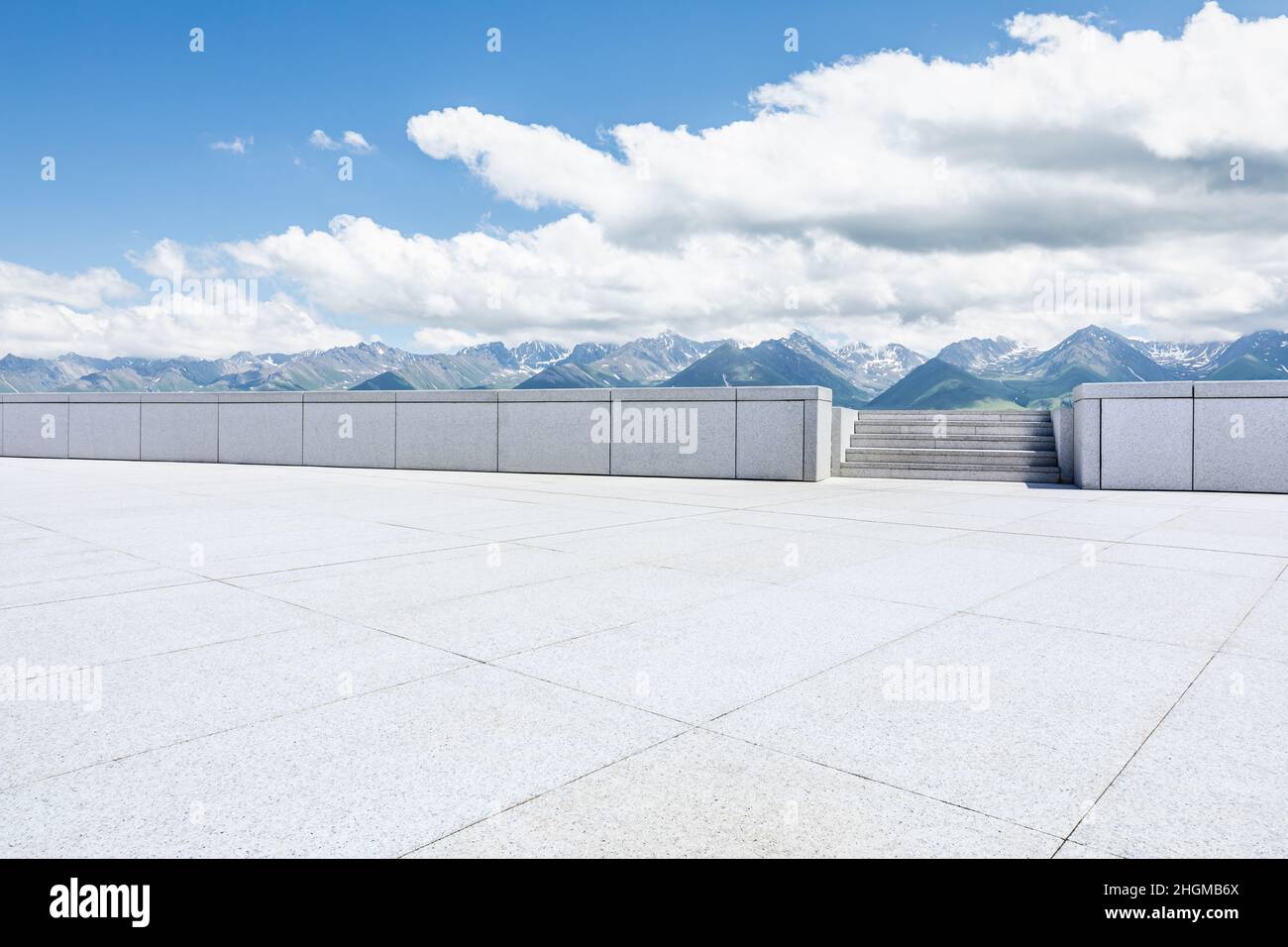 Empty square floor and mountains under blue sky Stock Photo