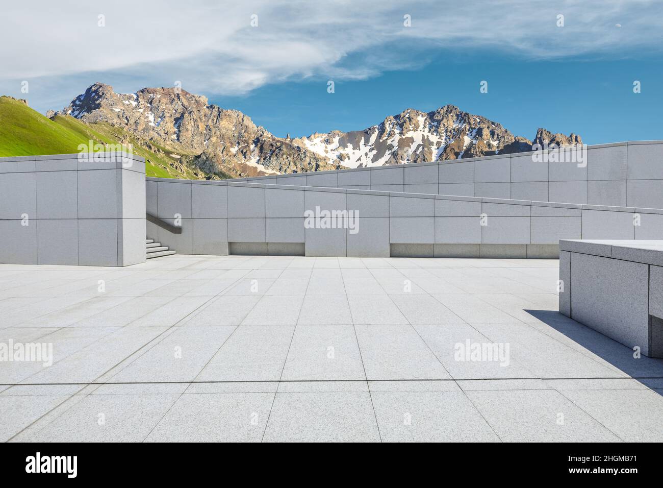 Empty square floor and mountains under blue sky Stock Photo