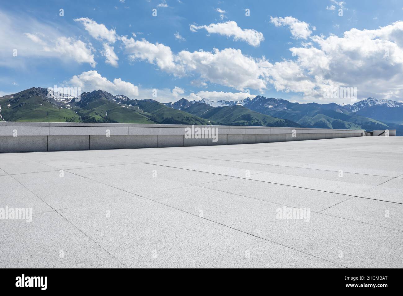 Empty square floor and mountains under blue sky Stock Photo