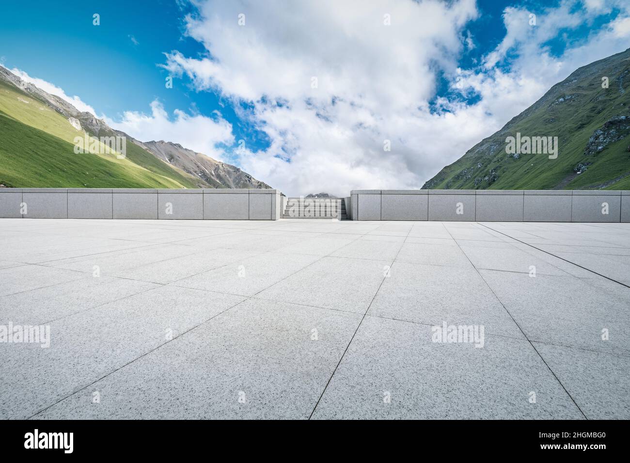 Empty square floor and mountains under blue sky Stock Photo