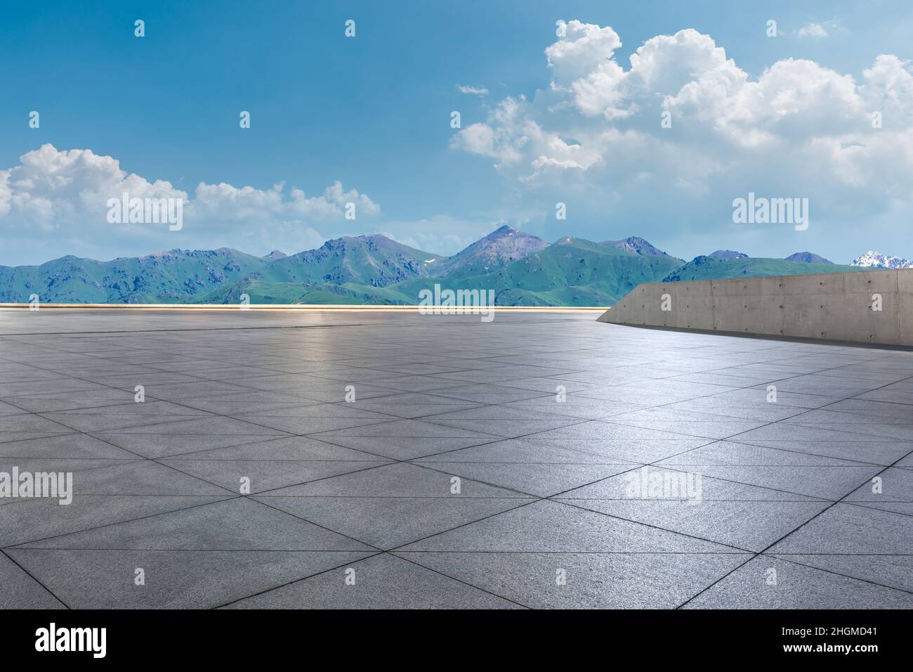 Empty square floor and mountains under blue sky Stock Photo