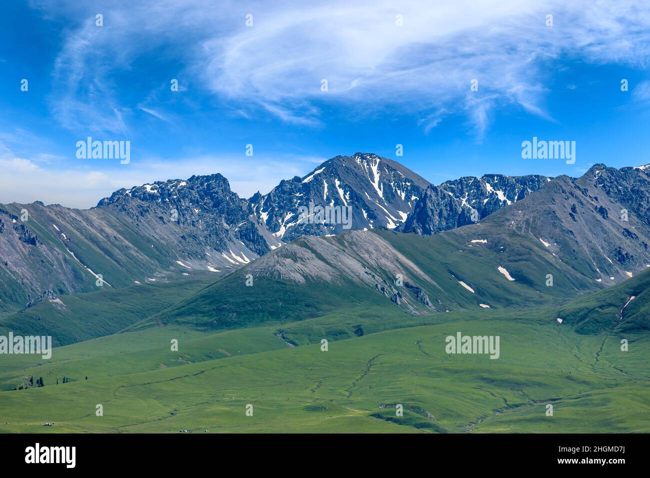 Beautiful mountains and green grassland Stock Photo