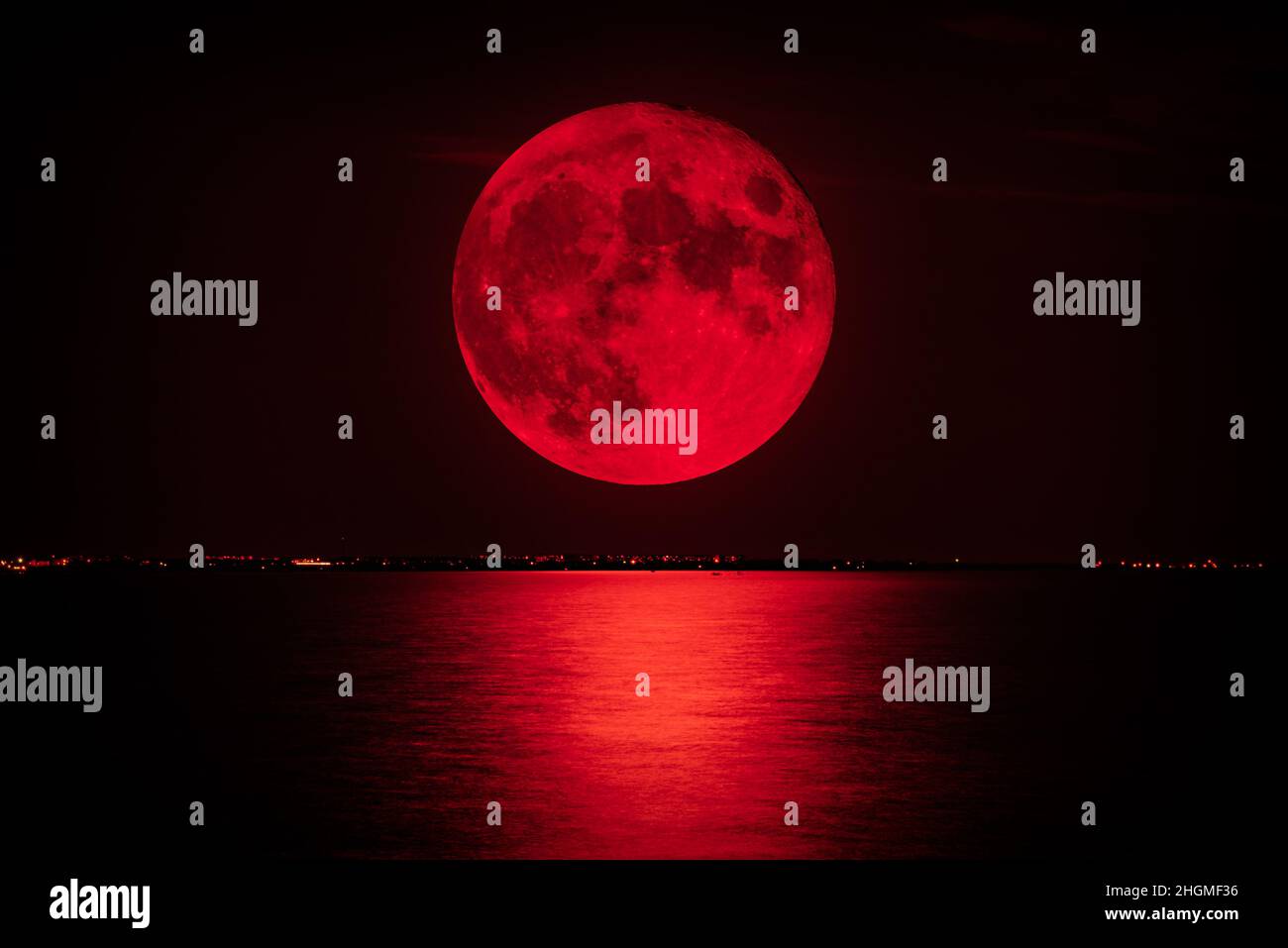 Full red moon over the sea Stock Photo