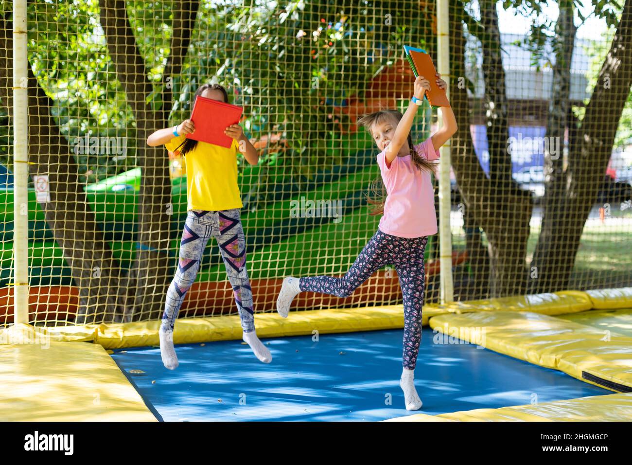Two girls on a trampoline hi-res stock photography and images - Alamy