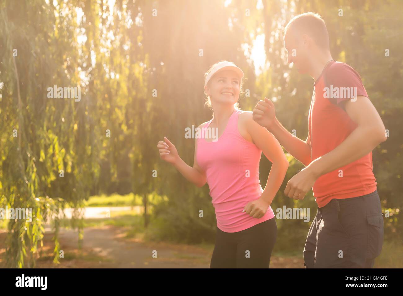 young couple enjoying in a healthy lifestyle while jogging along a ...