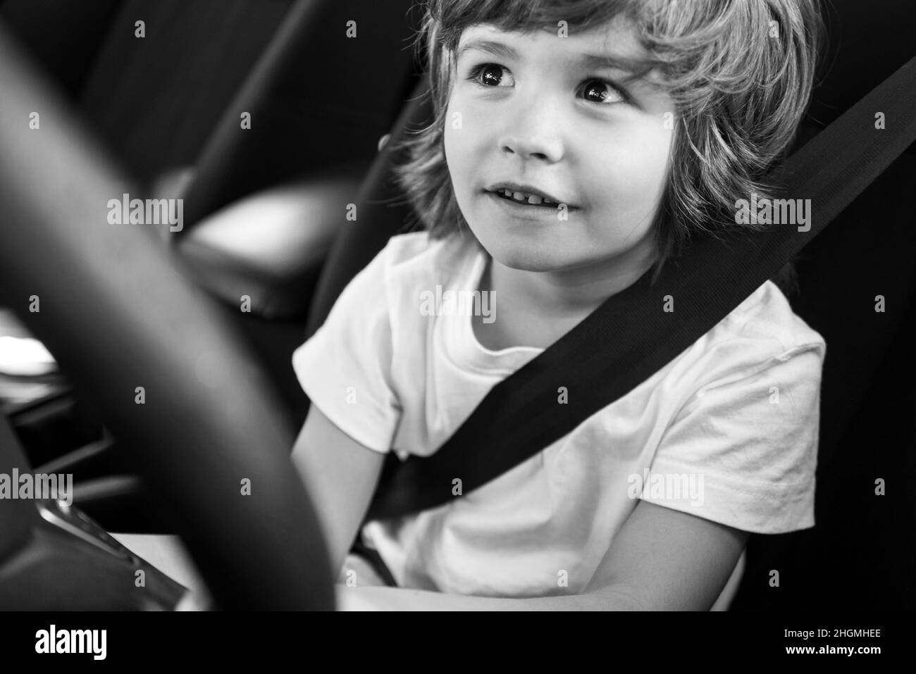 Child driver. Cute child boy while driving car as driver. Baby kid