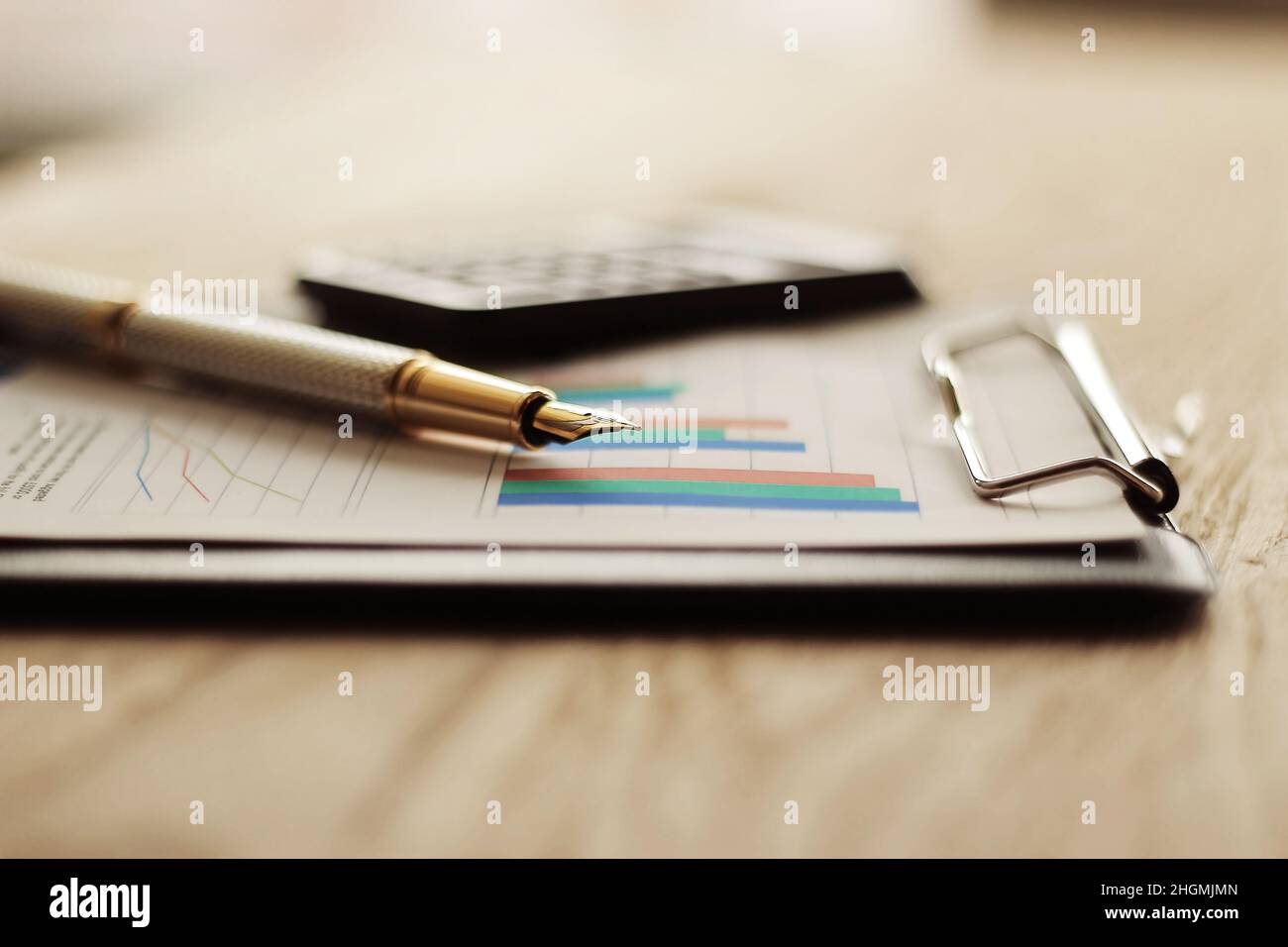 pen, calculator and financial graph on a workplace Stock Photo