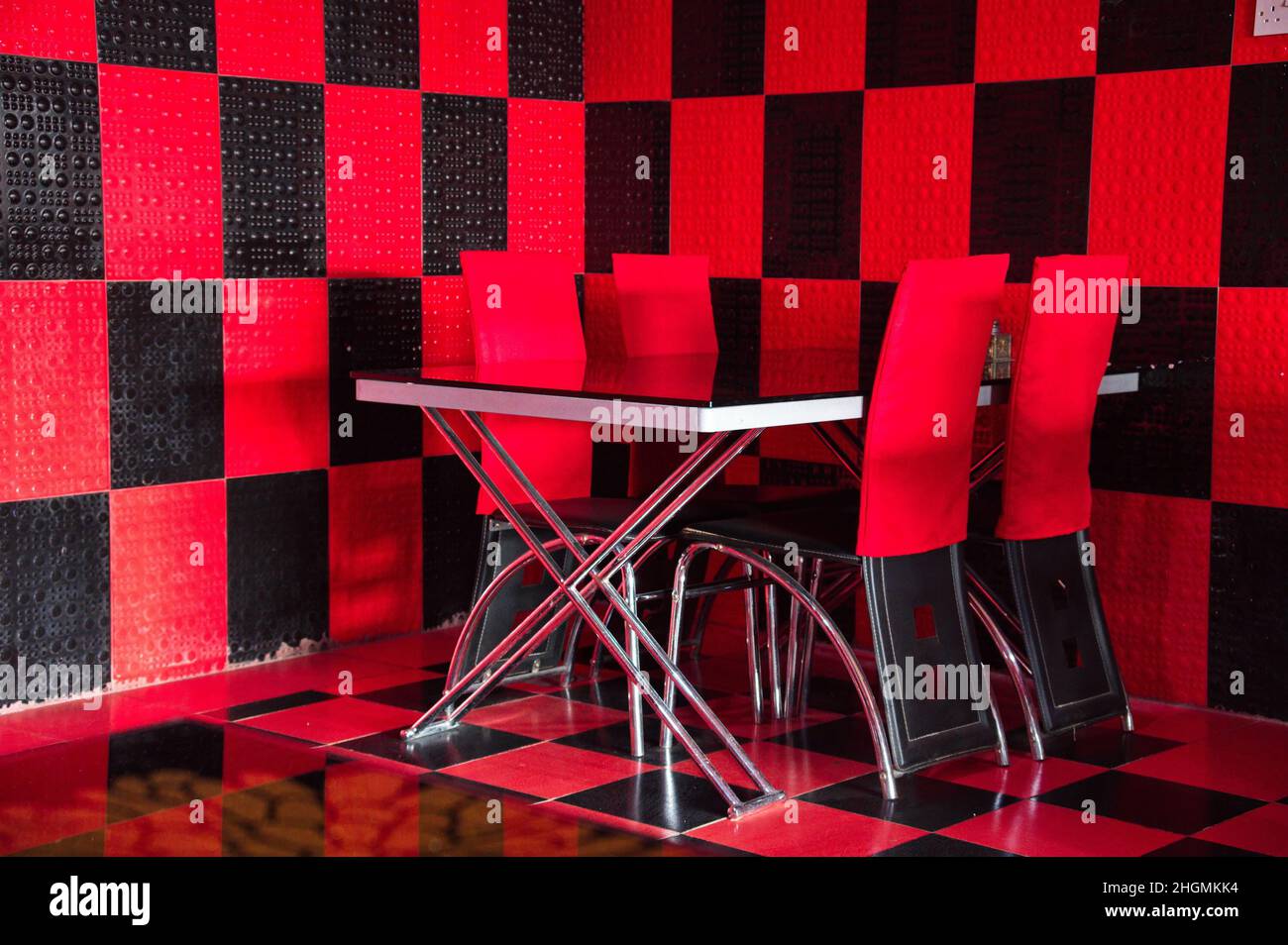 Table and chairs in red and black space Stock Photo