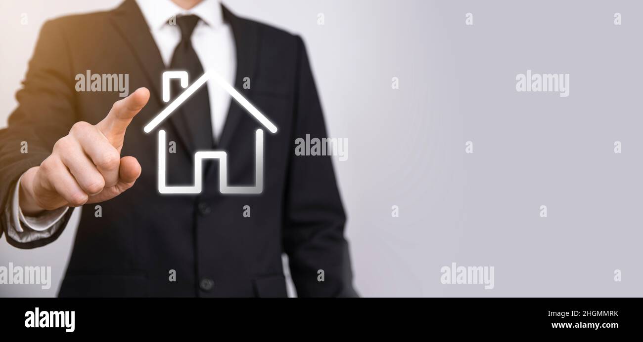 Real estate concept, businessman holding a house icon.House on Hand ...