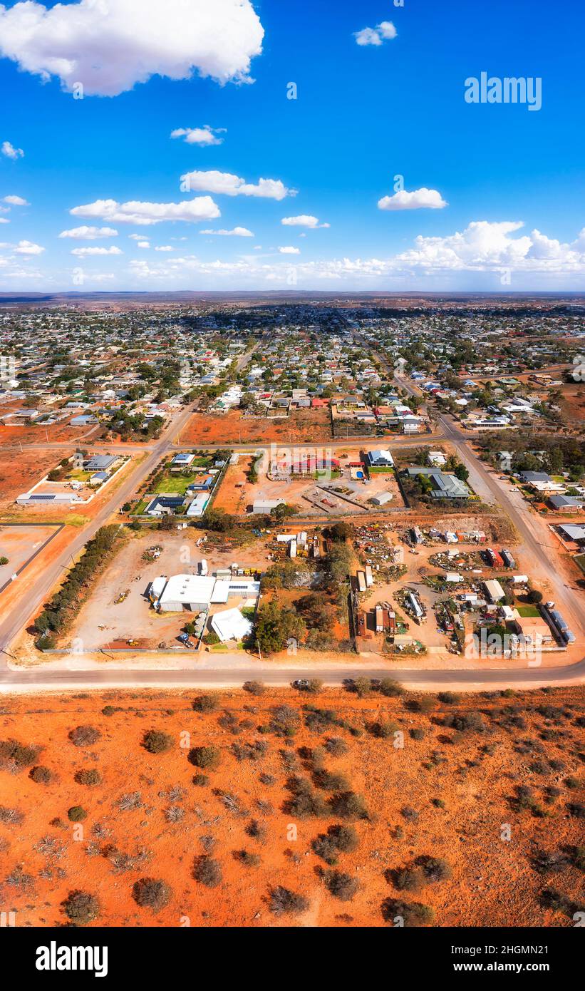 Red soil bushland outback at boundary of Broken hill town - aerial vertical panorama to downtown. Stock Photo