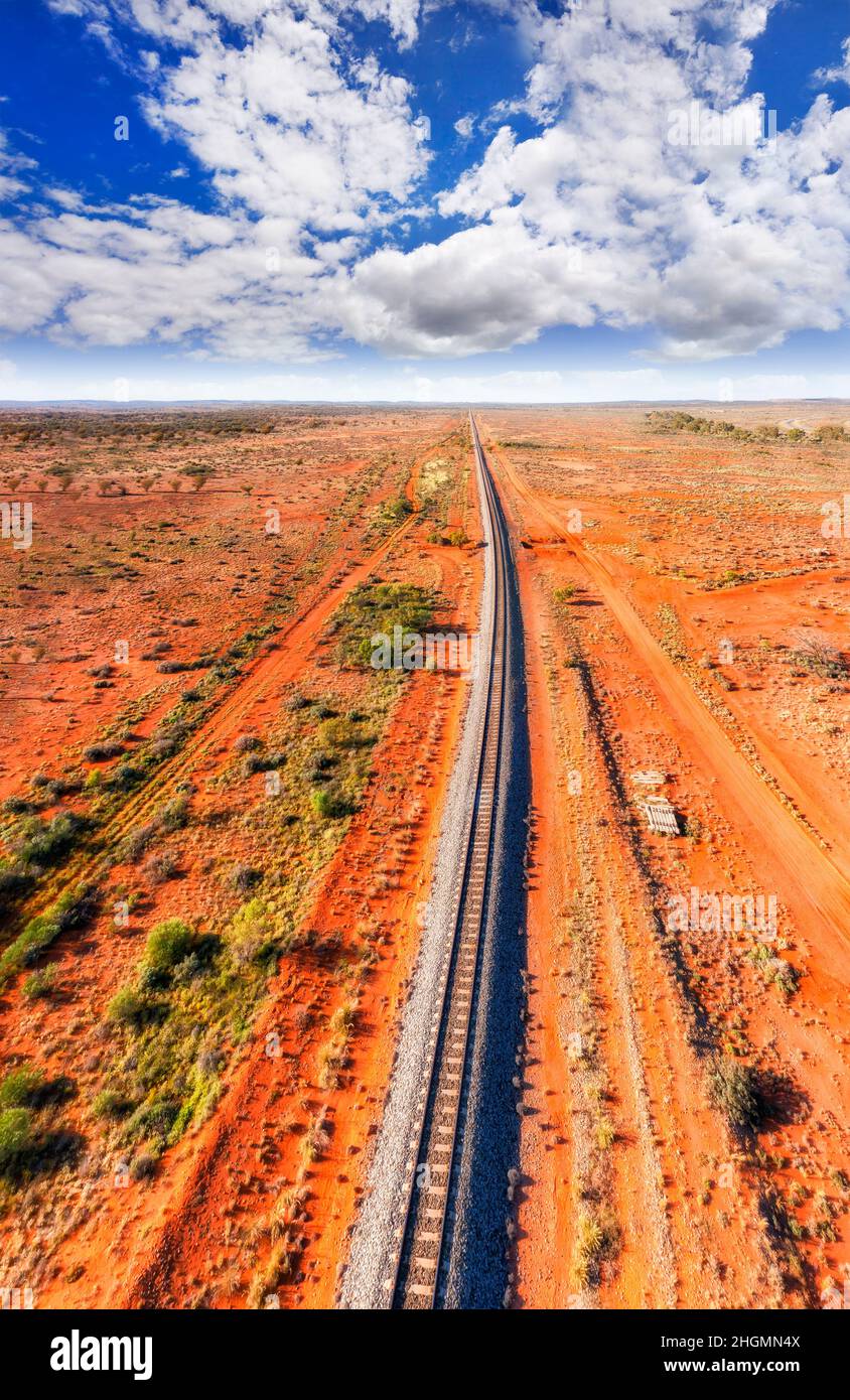 Red soil outback around railway road line leading to Broken Hill silver city of NSW Far West - aerial panorama. Stock Photo