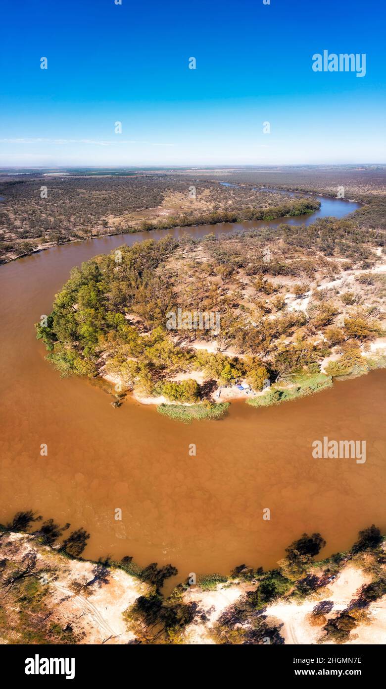 Mud in the waters of slow flowing Murray river in Australia - aerial vertical panorama. Stock Photo