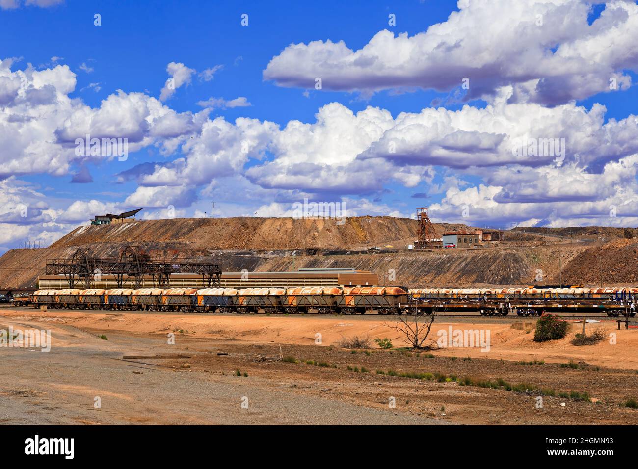 Metal ore on freight trains at Broken hill train station near open pit mine in Australian outback city of resources. Stock Photo