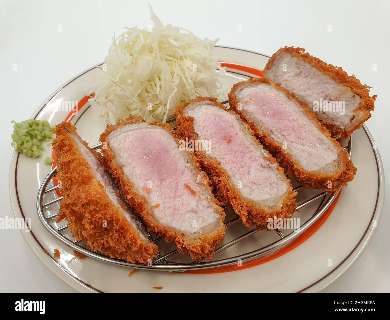 Tonkatsu, a Japanese breaded, deepfried pork cutlet. Served with cabbage salad and wasabi Stock
