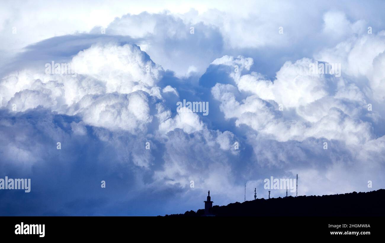 View of an impressive cloud above a mountain Stock Photo