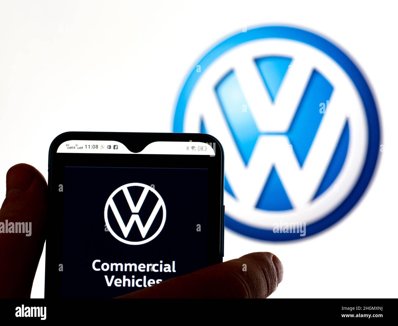 In this photo illustration, the Volkswagen Commercial Vehicles logo is seen displayed on a smartphone screen with a Volkswagen AG logo in the background. Stock Photo