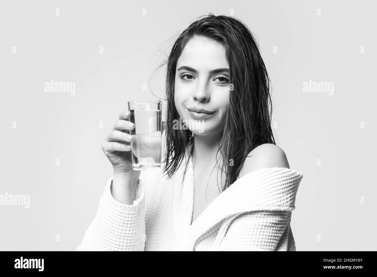Woman drinking water glass. Beautiful woman, female skin care, close up face beauty portrait. Stock Photo